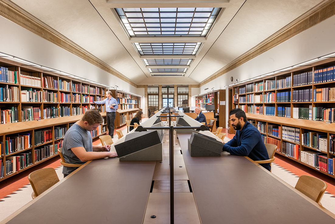 People sit at desks in a reading room